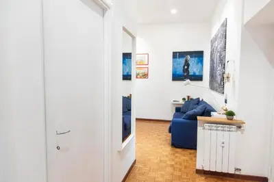 a hallway with a blue couch in a living room at Nova Domus Colosseo in Rome