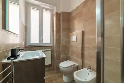 a small bedroom with a bed and a window at GuestHost - Monteverde Vecchio Apartment in Rome