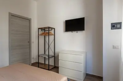 a room with a kitchen and a door with a shelf at GuestHost - Monteverde Vecchio Apartment in Rome