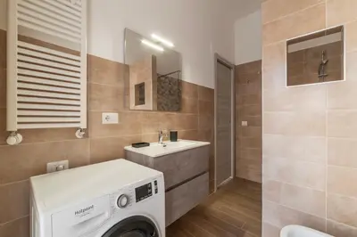 a white bedroom with a bed and a window at GuestHost - Monteverde Vecchio Apartment in Rome