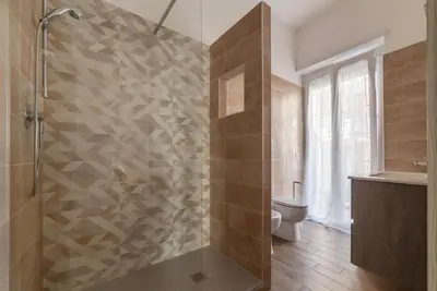a bathroom with a washing machine and a sink at GuestHost - Monteverde Vecchio Apartment in Rome