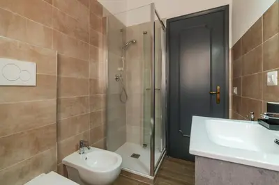 a bathroom with a shower and a toilet at GuestHost - Monteverde Vecchio Apartment in Rome