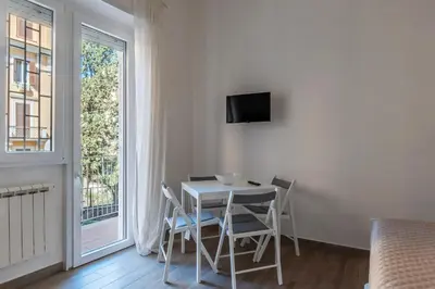 a small apartment with a table and a kitchen at GuestHost - Monteverde Vecchio Apartment in Rome
