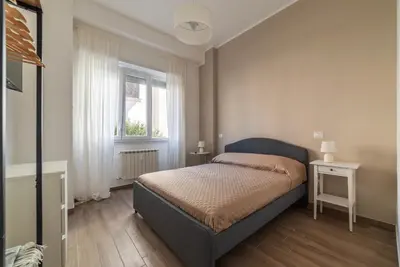 a bathroom with a shower with a wooden door at GuestHost - Monteverde Vecchio Apartment in Rome