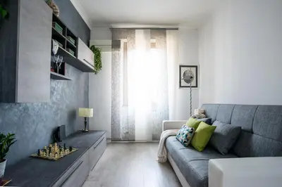 a living room with a gray couch and a chess board at Datama House in Rome