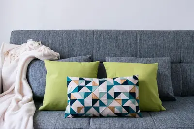 a gray couch with four pillows on it with at Datama House in Rome