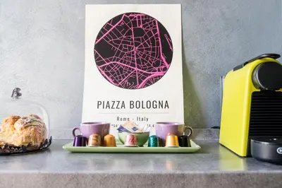 a plate of food and cups on a counter with a sign at Datama House in Rome