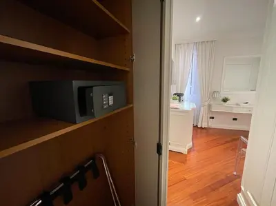 a room with a small tv on a shelf with a living room at Suite Fontana di Trevi in Rome