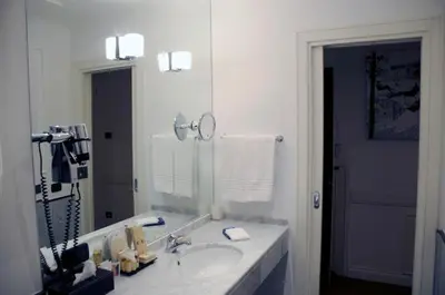 a bathroom with a sink and a large mirror at Suite Fontana di Trevi in Rome