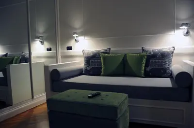 a living room with a couch with green pillows at Suite Fontana di Trevi in Rome