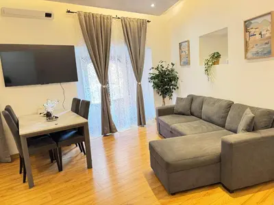 a living room with a couch and a table at Sweet House via dei gracchi in Rome