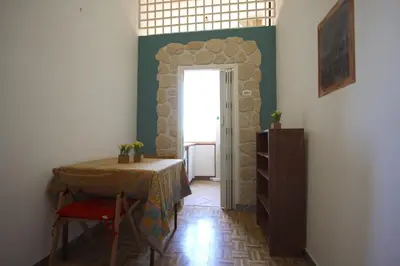 a room with a table and a door with a window at Sara Holiday House in Rome
