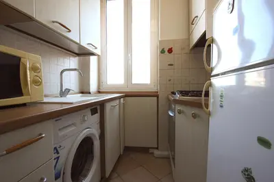 a kitchen with a washing machine and a refrigerator at Sara Holiday House in Rome
