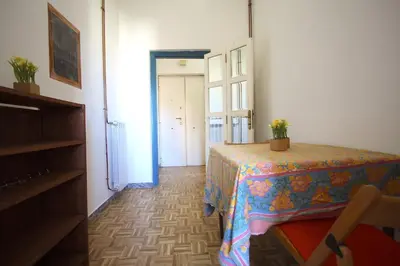 a room with a table and a door with a window at Sara Holiday House in Rome