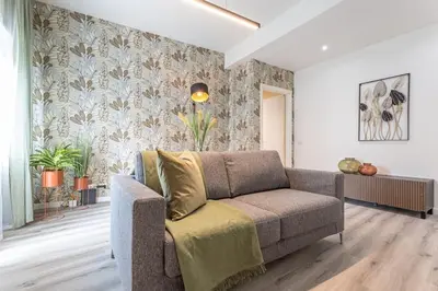 a living room with a couch and a wall at Cornelia Elegance House in Rome