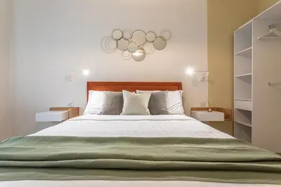 a bedroom with a large bed with a green blanket at Cornelia Elegance House in Rome