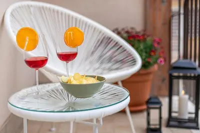 two glasses of red wine and a bowl of crisps and a bowl of chips at Cornelia Elegance House in Rome