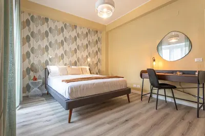 a bedroom with a bed and a desk at Cornelia Elegance House in Rome