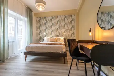 a bedroom with a bed and a desk and a table at Cornelia Elegance House in Rome