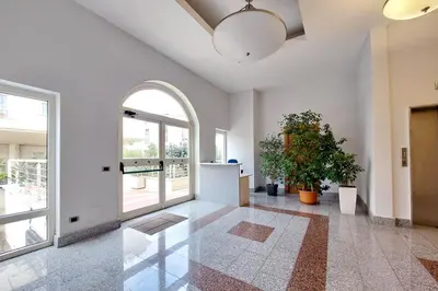 a hallway with an archway and a door with a plant at Homely Flat Porta Maggiore in Rome