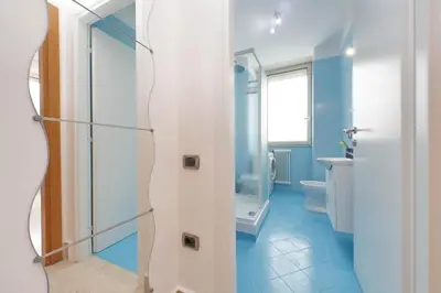 a bathroom with a toilet and a glass shower at Homely Flat Porta Maggiore in Rome