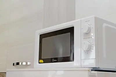 a white microwave oven sitting on top of a counter at Homely Flat Porta Maggiore in Rome
