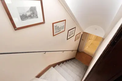 a staircase in a house with two pictures on the wall at Domus Monamì Apartment in Rome