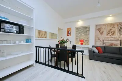 a living room with a table and a couch at Domus Monamì Apartment in Rome