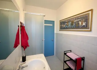 a bathroom with a sink and a painting on the wall at CASA UMBERTO in Rome