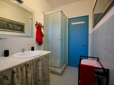a bathroom with a sink and a blue door at CASA UMBERTO in Rome