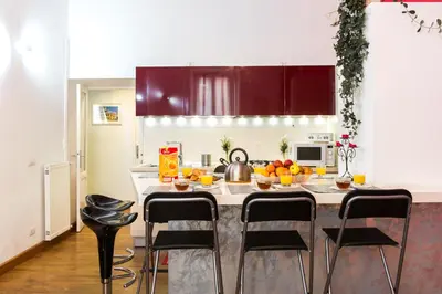 a kitchen with a kitchen island with fruits on it at Home Candia in Rome