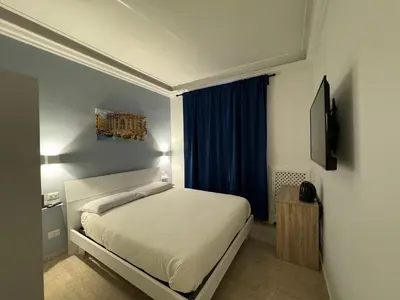 a small bedroom with a bed and a window at Costantino Rooms in Rome