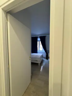 an open door to a bedroom with a bed at Costantino Rooms in Rome