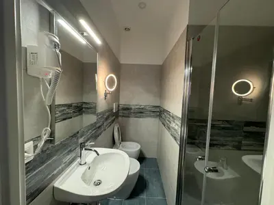 a bathroom with a sink and a shower and a toilet at Costantino Rooms in Rome