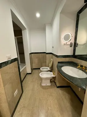 a bathroom with two toilets and a sink at Costantino Rooms in Rome
