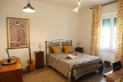 a bedroom with a bed and a guitar in it at Porta Maggiore Modern Apartment in Rome