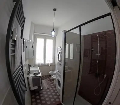 a bathroom with a shower and a toilet and a mirror at Porta Maggiore Modern Apartment in Rome
