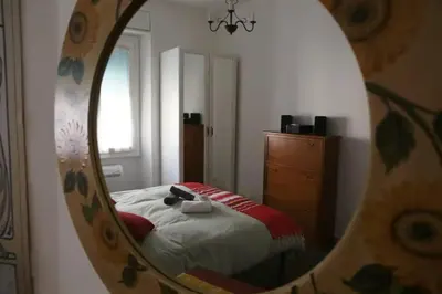 a bedroom with a bed and a mirror at Porta Maggiore Modern Apartment in Rome
