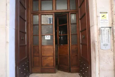 a pair of wooden doors on a building at Porta Maggiore Modern Apartment in Rome