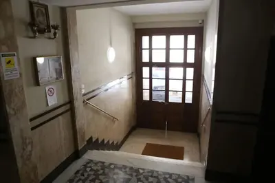 a hallway with a door and a window in a building at Porta Maggiore Modern Apartment in Rome