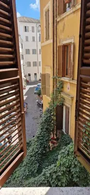 an alley with ivy growing on the side of a building at Pantheon Boutique Apartment in Rome