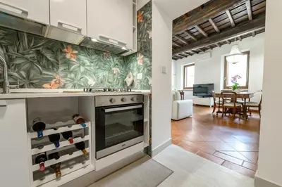 a kitchen with a stove and a living room at Pantheon Boutique Apartment in Rome