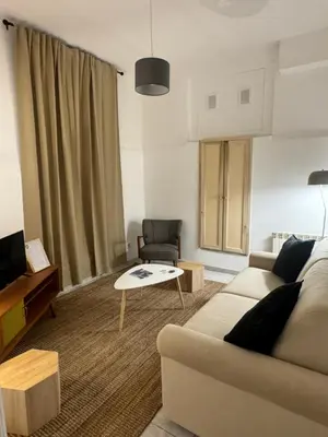 a living room with a couch and a table at Pietra Apartment 2 , Colosseo in Rome