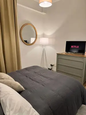 a bedroom with a bed and a mirror and a desk at Pietra Apartment 2 , Colosseo in Rome