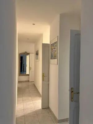 a hallway with two doors and a tile floor at Pietra Apartment 2 , Colosseo in Rome