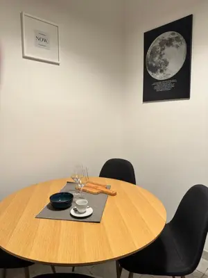a wooden table with black chairs and a table with a bowl and a cup at Pietra Apartment 2 , Colosseo in Rome