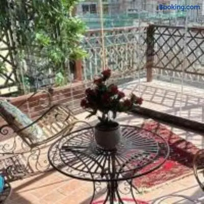 a vase of flowers sitting on a table on a balcony at Lovely Terrace Aurelia in Rome
