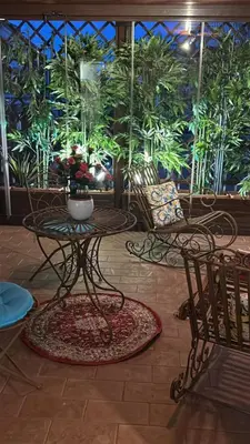a room with a table and chairs and plants at Lovely Terrace Aurelia in Rome