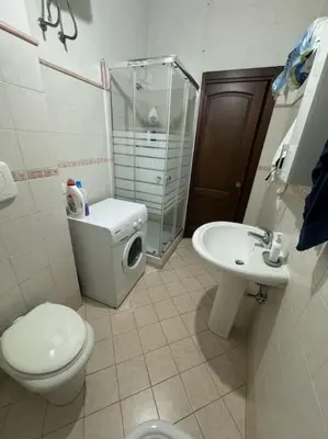 a bathroom with a toilet and a sink at Trastevere Marconi Apartment in Rome