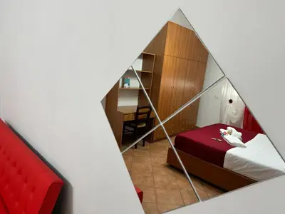 a small room with a bed and a desk at Trastevere Marconi Apartment in Rome